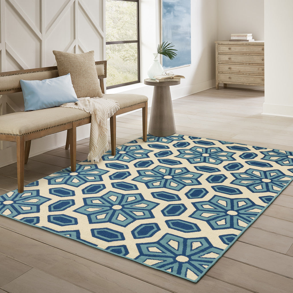 7' x 10' Ivory and Blue Geometric Stain Resistant Indoor Outdoor Area Rug