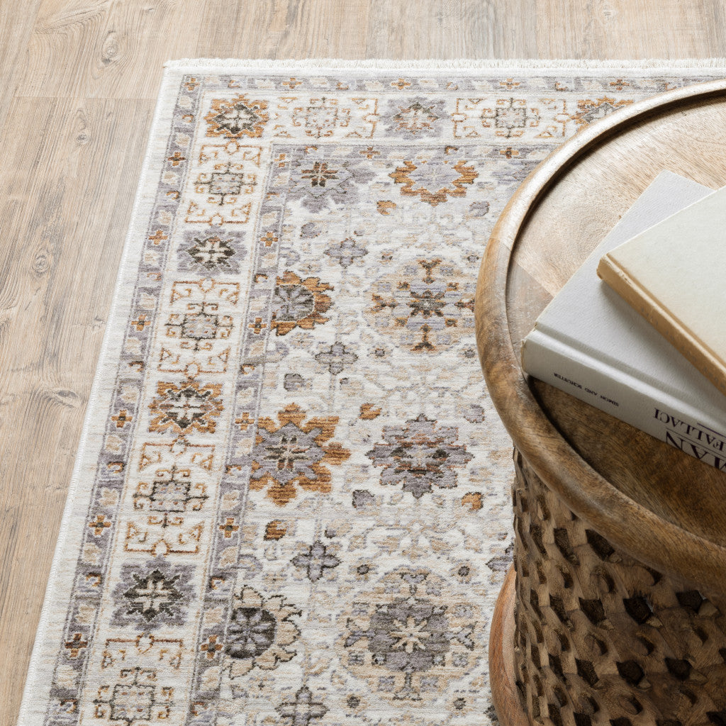 10' X 13' Ivory And Gold Oriental Power Loom Stain Resistant Area Rug With Fringe