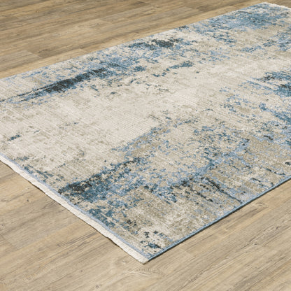 10' X 13' Blue Grey Ivory Light Blue And Dark Blue Abstract Power Loom Stain Resistant Area Rug With Fringe