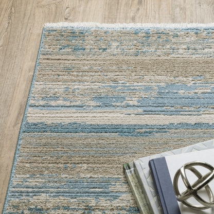 10' X 13' Ivory Beige Grey Blue And Tan Abstract Power Loom Stain Resistant Area Rug With Fringe