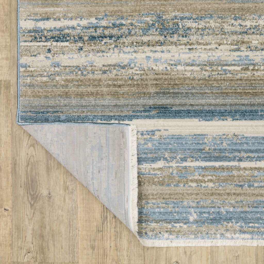 10' X 13' Ivory Beige Grey Blue And Tan Abstract Power Loom Stain Resistant Area Rug With Fringe