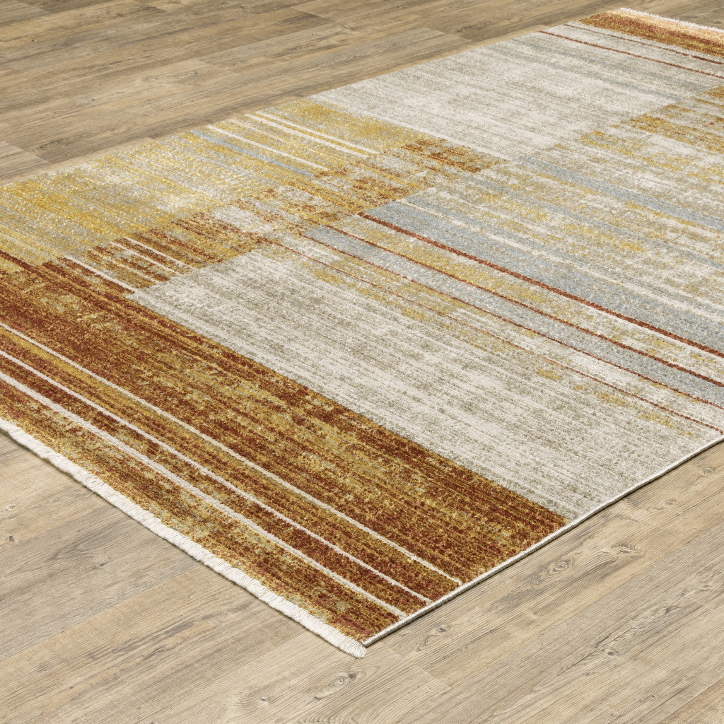 10' X 13' Rust Gold Blue Grey Ivory And Tan Geometric Power Loom Stain Resistant Area Rug With Fringe