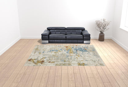 10' X 13' Beige Grey Gold Blue Rust And Teal Abstract Power Loom Stain Resistant Area Rug With Fringe